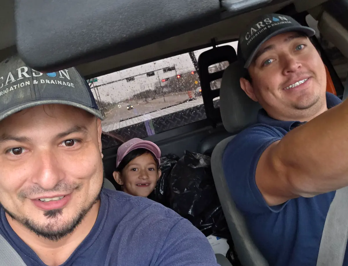 The Carson Irrigation team, partners and daughter in the work truck